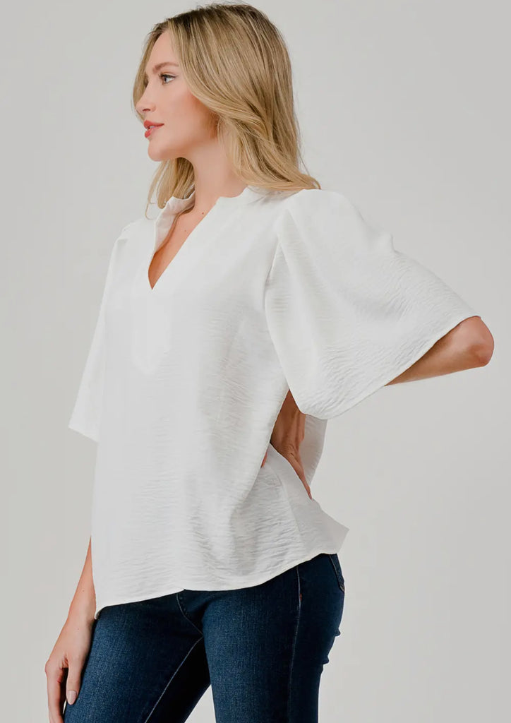 White flutter sleeve blouse